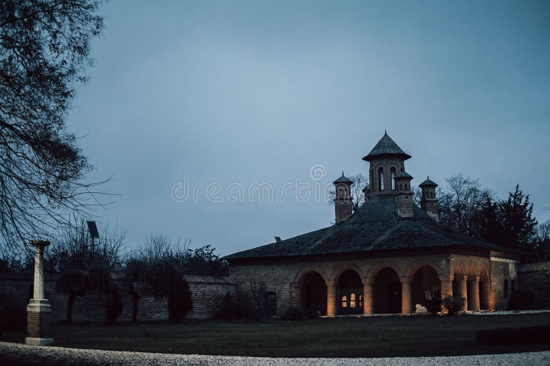 Areal shot of a stone building illuminated by a cloudy night sky stock photos