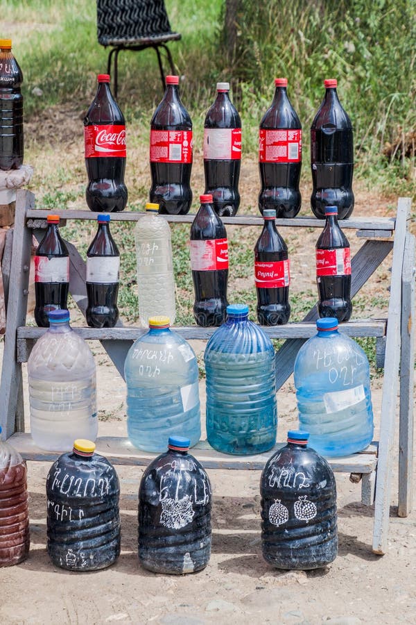 ARENI, ARMENIA - JULY 7, 2017: Roadside stall selling local wine (disguised in Cola Cola bottles) in Areni village, Armen. Ia stock photography ARENI, ARMENIA - JULY 7, 2017: Roadside stall selling local wine (disguised in Cola Cola bottles) in Areni village, Armen. Ia stock photography