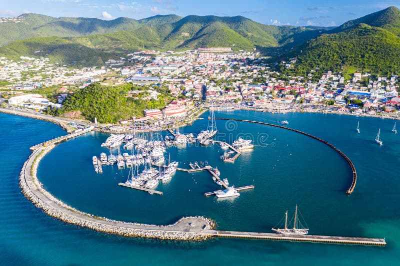 Arial view of Marigot, the main town and capital in the French Saint Martin, sharing the same island with dutch Sint Maarten. Fort St. Louis on a hill, yachts and a circular breakwaters of the marina. Arial view of Marigot, the main town and capital in the French Saint Martin, sharing the same island with dutch Sint Maarten. Fort St. Louis on a hill, yachts and a circular breakwaters of the marina