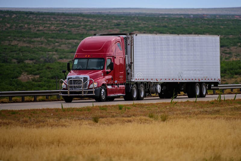 Arizona, USA - May, 2020: Trucks on American roads. Delivery. A big red truck and a trailer with space for text on the