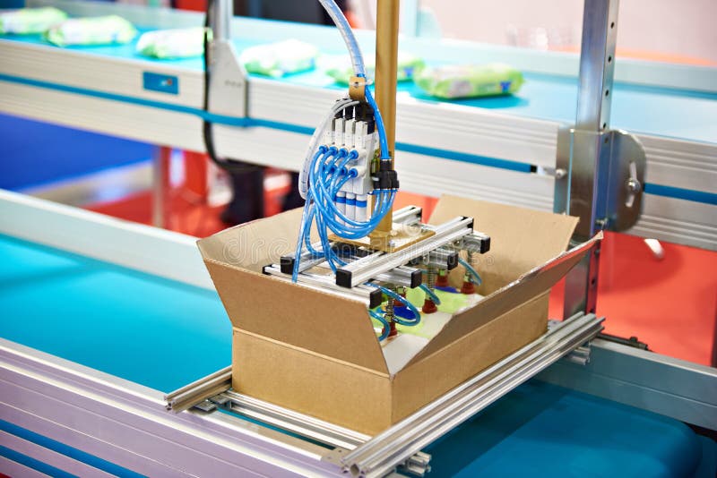 Hand robot manipulator for packaging products cardboard box on conveyor. Hand robot manipulator for packaging products cardboard box on conveyor