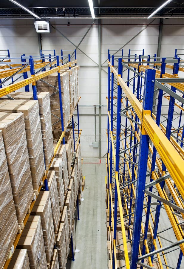 The racks and shelves of a huge warehouse seen from above. The racks and shelves of a huge warehouse seen from above