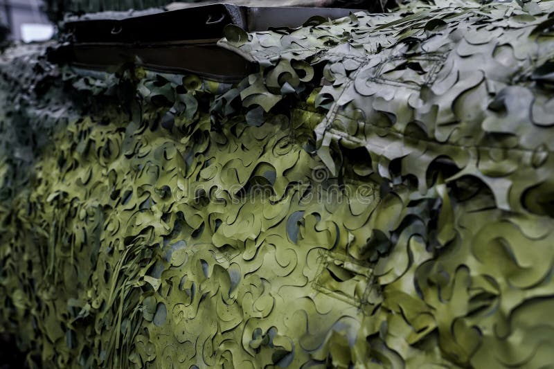 Armoured military vehicle camouflage cover - tarpaulin mesh, closeup detail royalty free stock photos