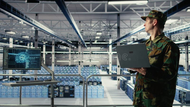 Army soldier in server farm uses artificial intelligence program on laptop stock video