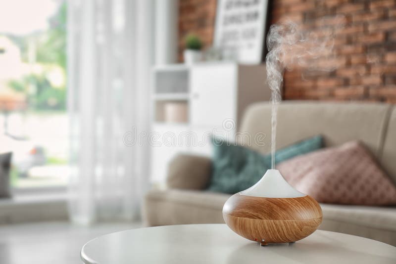 Aroma oil diffuser on table at home