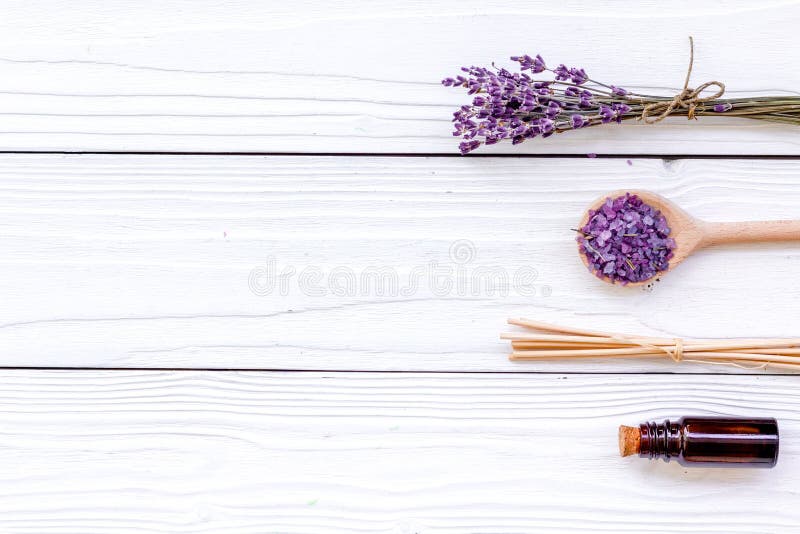 Aromatherapy for relax concept. Lavender branch, spa salt and oil on white wooden background top view copyspace royalty free stock photo Aromatherapy for relax concept. Lavender branch, spa salt and oil on white wooden background top view copyspace royalty free stock photo