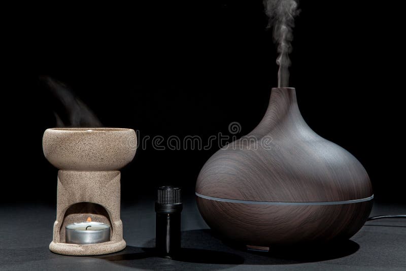 Aromatherapy. Traditional and modern oil burner and aroma diffuser working with essential oil bottle. stock photography Aromatherapy. Traditional and modern oil burner and aroma diffuser working with essential oil bottle. stock photography