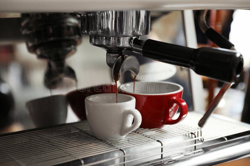 Aromatic coffee pouring into cups from modern machine stock photos Aromatic coffee pouring into cups from modern machine stock photos