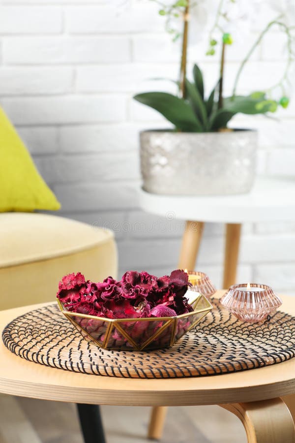 Aromatic Potpourri of Dried Flowers in Bowl and Burning Candles on