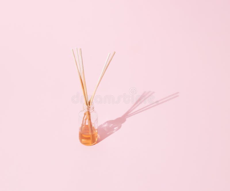 Aromatic Wooden Sticks in Perfume. Pastel Pink Bacgroundk Stock Photo