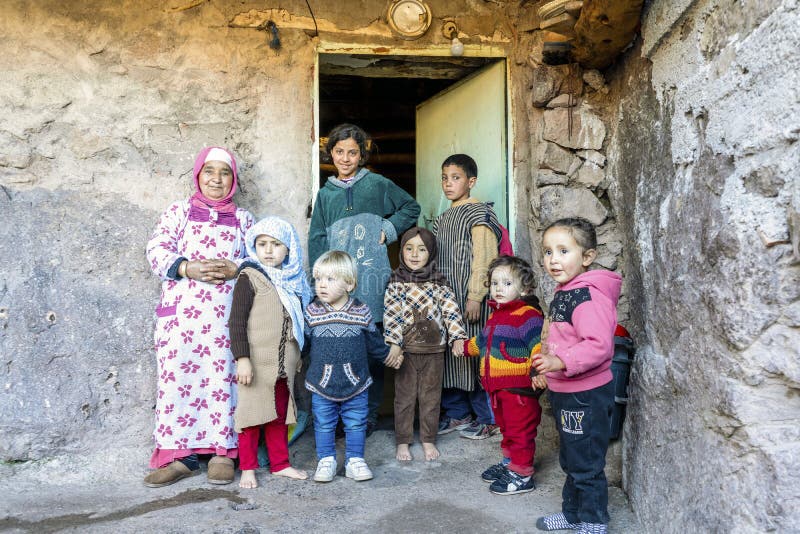 Berber grandmother taking care of many kids in front of her house stock image Berber grandmother taking care of many kids in front of her house stock image