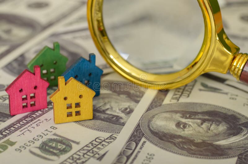 The arrangement of the houses and the magnifying glass implies that a systematic approach is necessary when searching for a home stock photography