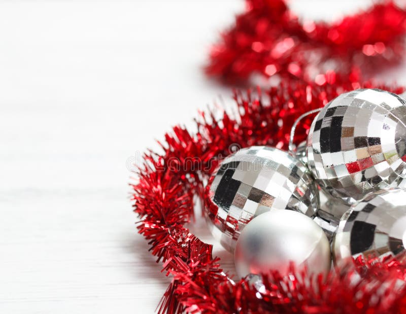 Arrangement with silver baubles and red garland