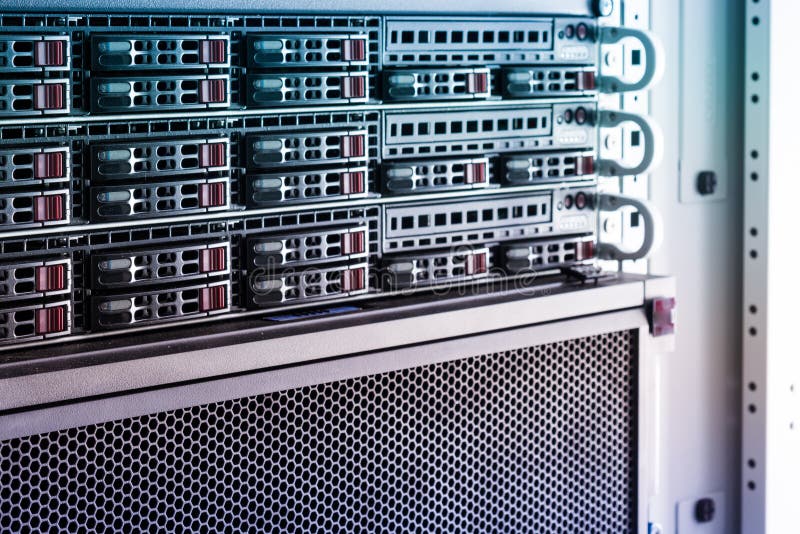 Array of data storage hard drives in internet data center. Row of hard drives serving as data storage inside server room
