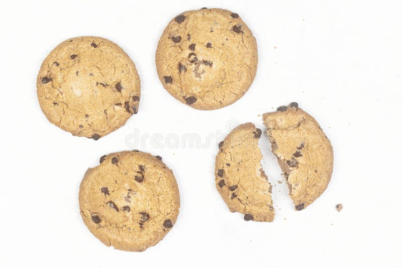Array of freshly baked chocolate chip cookies arranged in a neat row on a table royalty free stock image