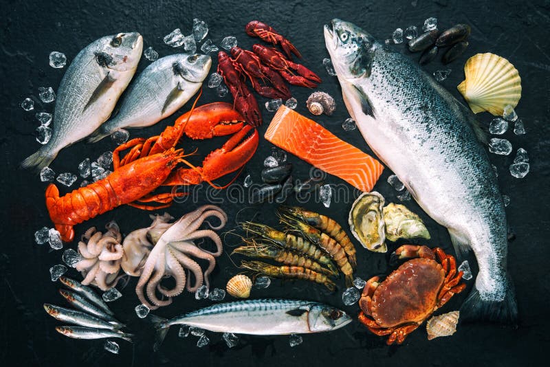 Arreglo de los pescados frescos y de los mariscos en piedra negra fotografía de archivo libre de regalías