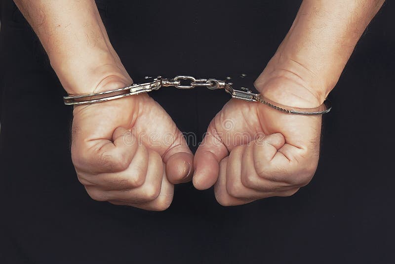Criminal Hands Locked in Handcuffs. Closeup View Stock Image Image