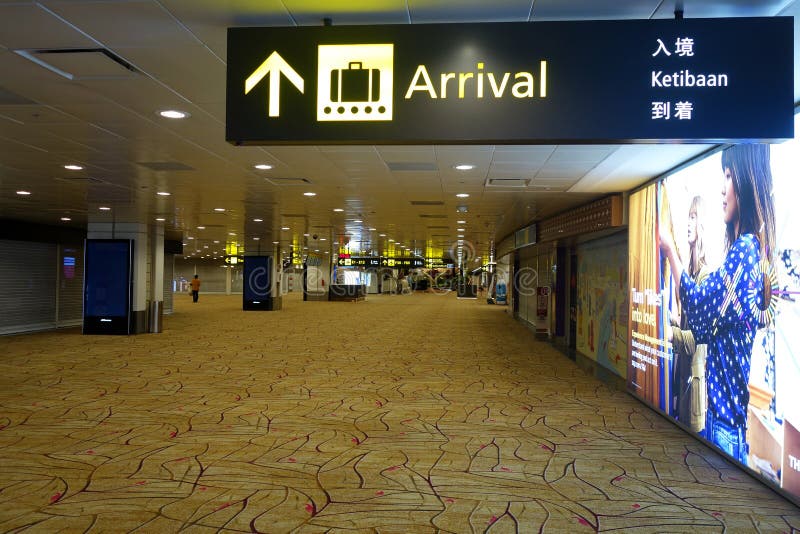 Arrival Sign and Flowers at Singapore Changi Airport Editorial Stock