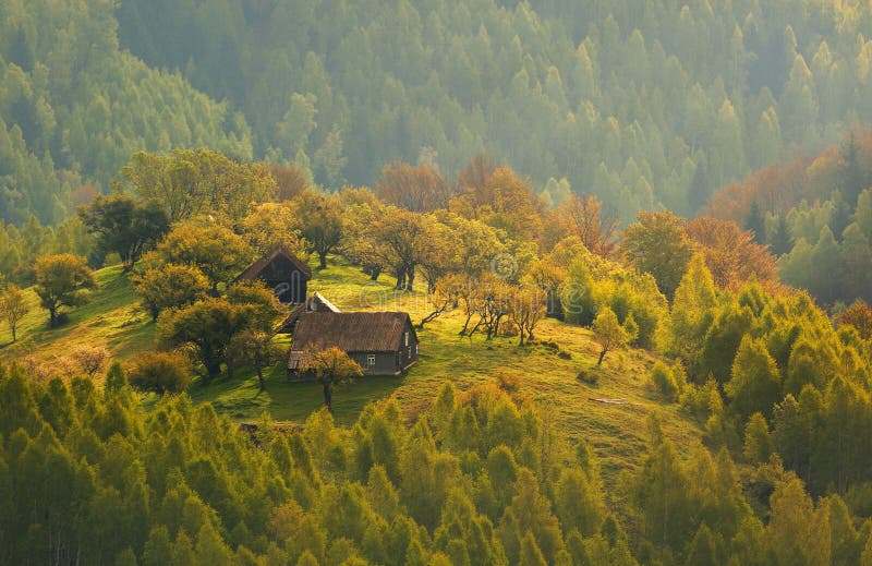 Autumn landscape at sunrise in Transylvania, Romania - traditional house on a hill in the forest - Morning Mist. Autumn landscape at sunrise in Transylvania, Romania - traditional house on a hill in the forest - Morning Mist.