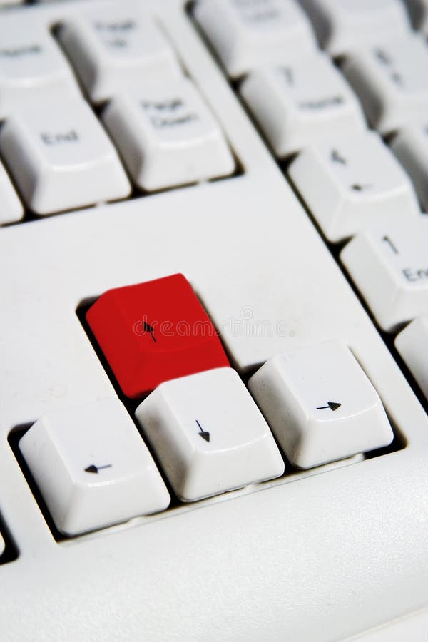 Arrow keys on a desktop computer keyboard with the up arrow red. Arrow keys on a desktop computer keyboard with the up arrow red