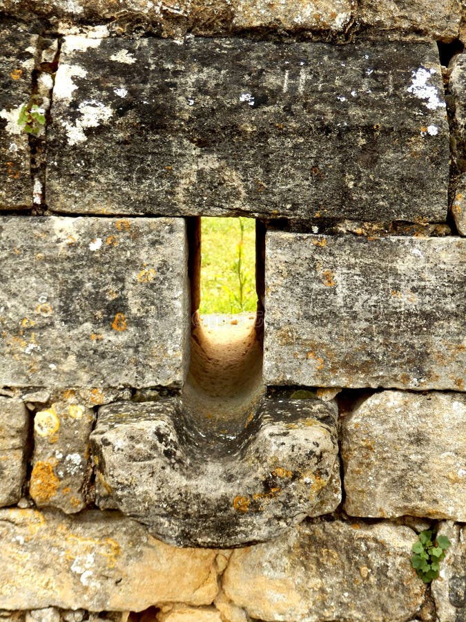 Arrow slit in medieval wall stock image