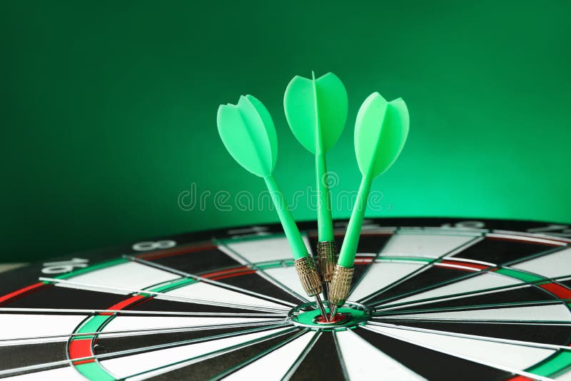 Arrows hitting target on dart board