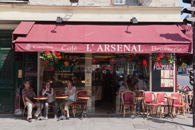 Cafe LÂ´Arsenal, typical brasserie at a corner of downtown Paris, France. Cafe LÂ´Arsenal, typical brasserie at a corner of downtown Paris, France.