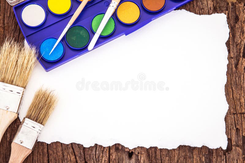 Art brush watercolor paint with white paper art on wooden backg