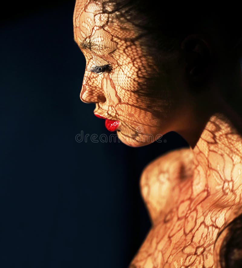 Art Deco. Ethnic Woman's Face with Reflex of Openwork Lace - Fancy Makeup