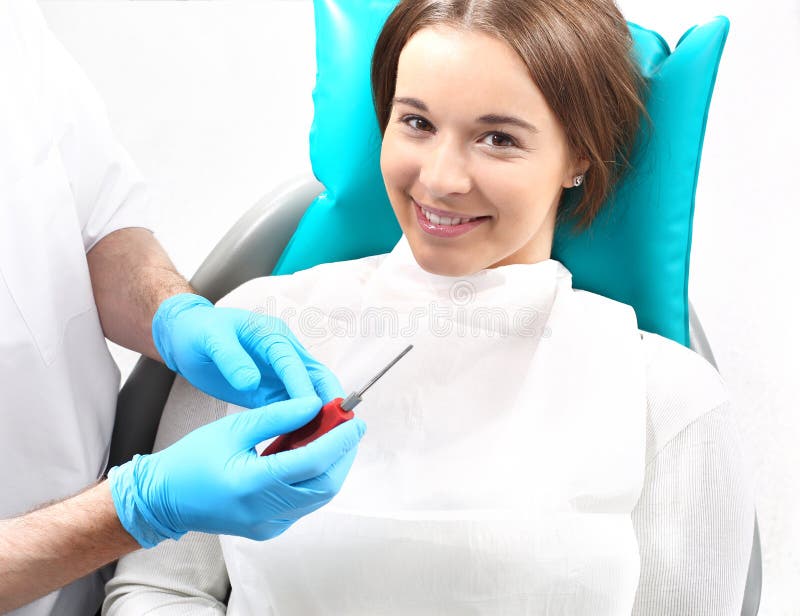 Woman at the dentist's chair during a dental procedure. Woman at the dentist's chair during a dental procedure