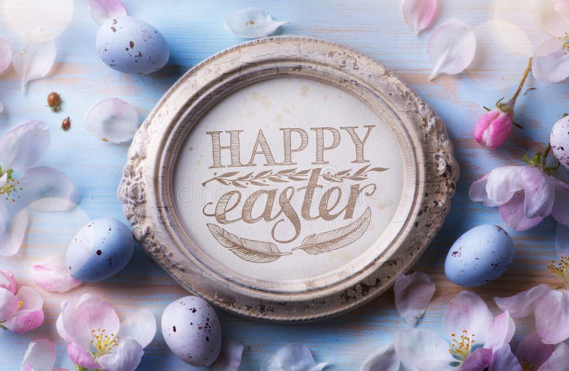 Happy Easter Background; Easter egg and spring flowers on blue t royalty free stock photos