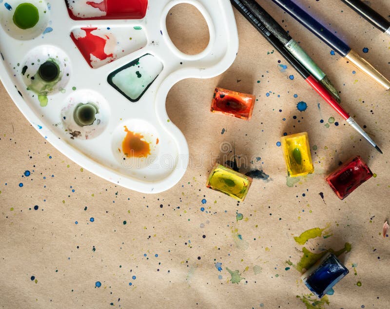 Art Palette with Brushes and Paint Boxes on Table Stock Image