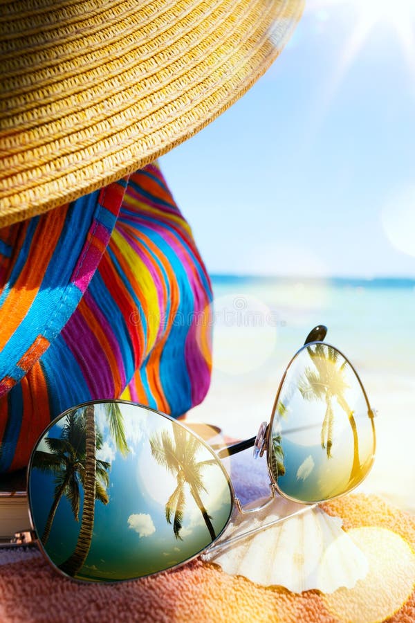 Art Straw hat and sun glasses on a tropical beach
