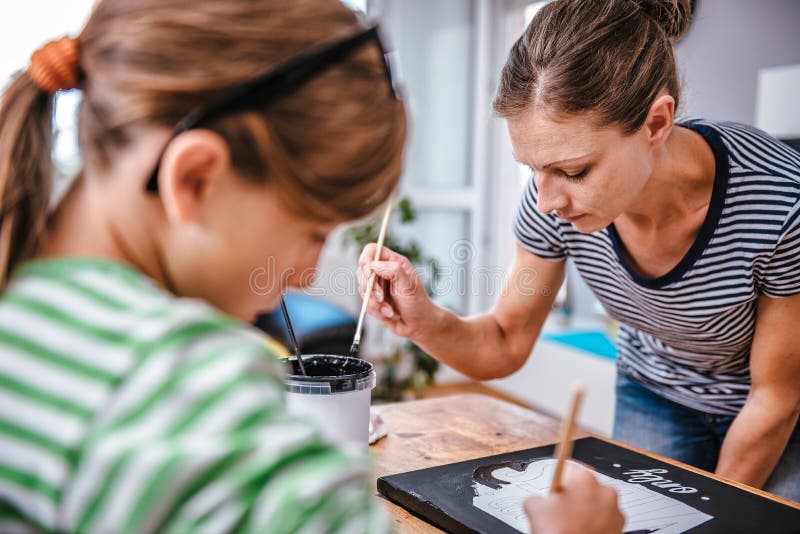 Art Teacher Helping a Student with Painting Stock Image Image of