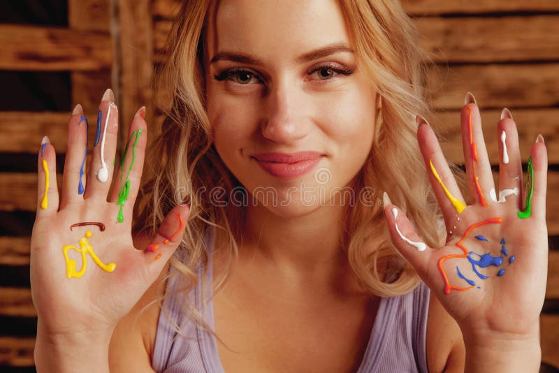 Art therapie concept. Beautiful young woman with colorful painted hands. Horizontal image stock photos