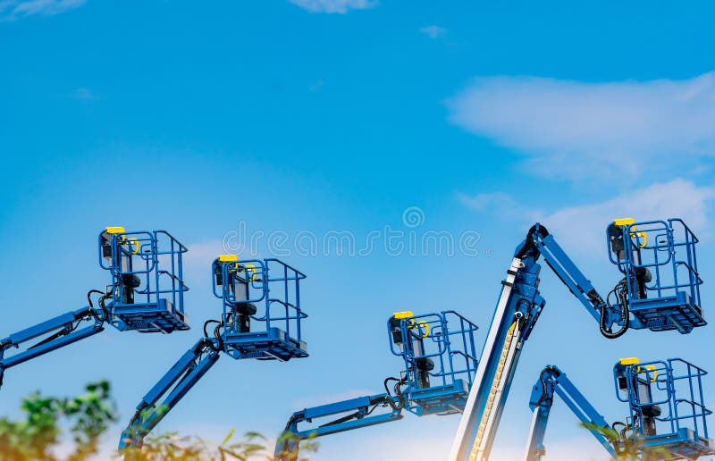 Articulated boom lift. Aerial platform lift. Telescopic boom lift against blue sky. Mobile construction crane for rent and sale.