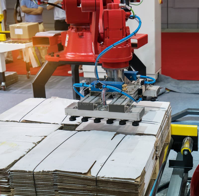 Articulated robotic arm at packaging line in factory