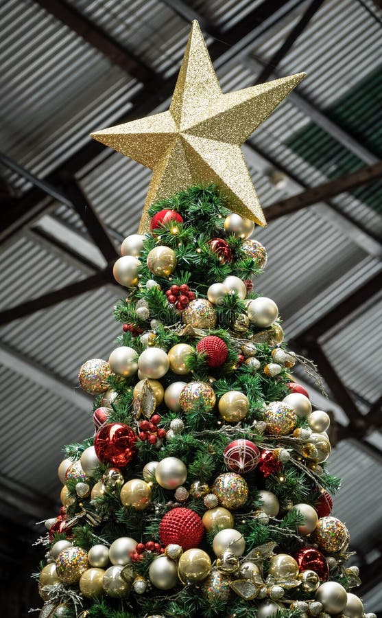 Artificial Christmas Tree with Red and Gold Balls and Star Stock Photo