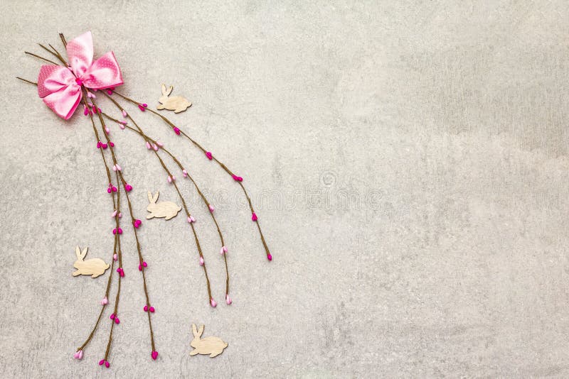 Artificial decorative multicolored willow twigs and wooden figures of bunny. The concept of Easter cards, wallpapers, backgrounds stock images