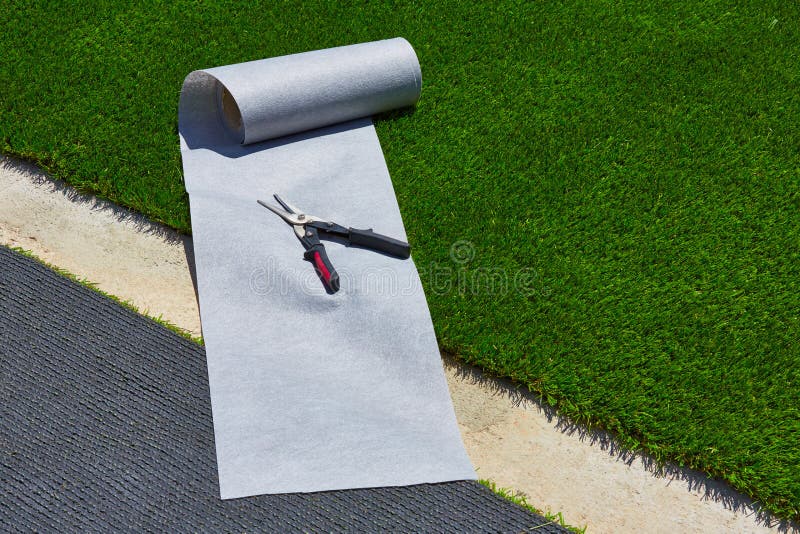 Artificial Grass Turf Installation In Garden With Tools Stock Photo