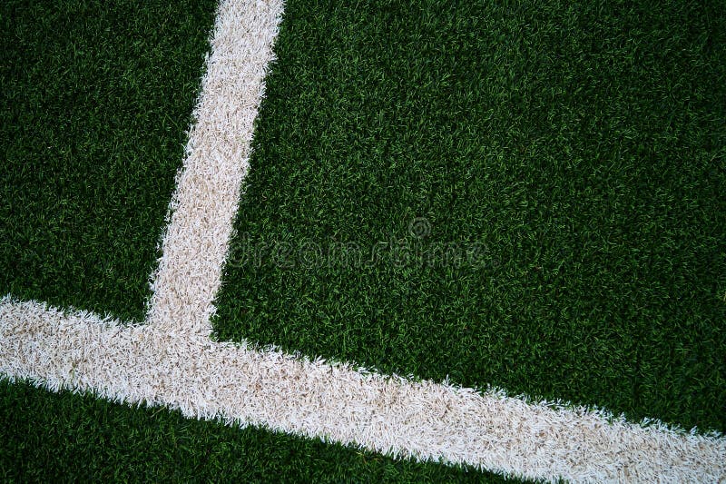 Artificial green grass with darker edges and with white up-side down shifted T to the far left royalty free stock photography Artificial green grass with darker edges and with white up-side down shifted T to the far left royalty free stock photography