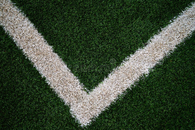 Artificial green grass with a V shaped white line that is slightly routed to the left at the bottom stock image Artificial green grass with a V shaped white line that is slightly routed to the left at the bottom stock image