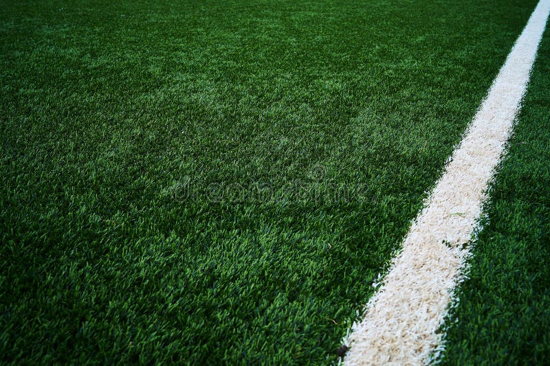 Artificial green grass with a white line that is routed to the right and is going up-wards royalty free stock photo Artificial green grass with a white line that is routed to the right and is going up-wards royalty free stock photo