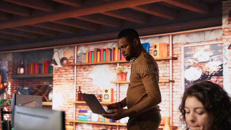 Artificial intelligence company worker arriving in office with laptop stock photography