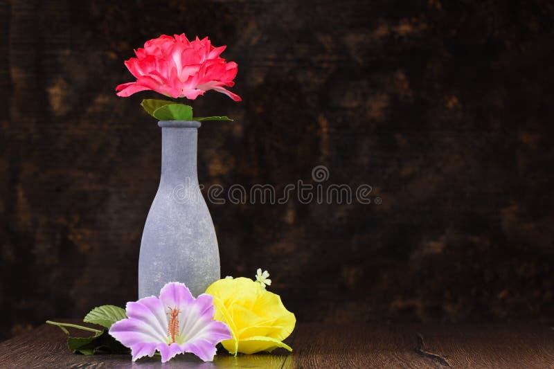Artificial Red and Yellow Artificial Roses and Bindweed Flowers Stock