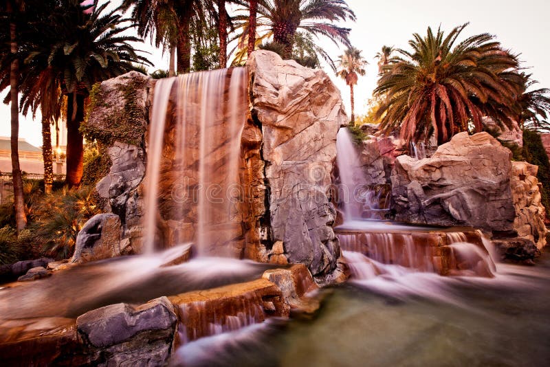 Artificial waterfall with palm trees