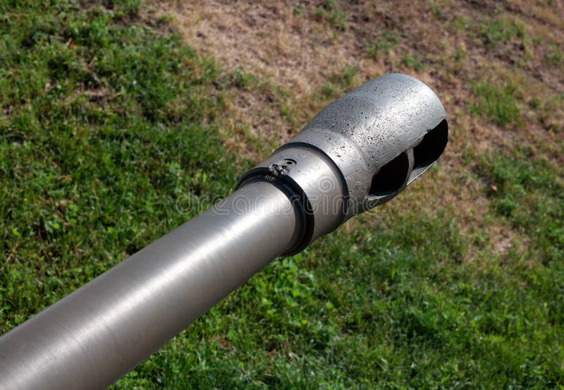 Artillery Gun Barrel Close Up. Muzzle Brake on Cannon Barrel Green