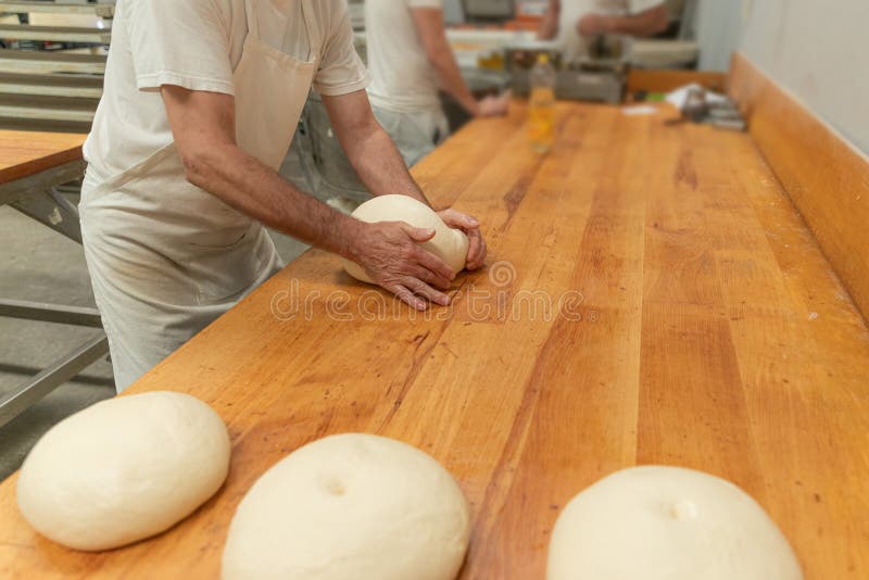In an Artisan Bakery, a Baker Prepare the Bread Dough Stock Image