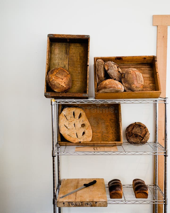 Artisan Bread on a Shelf Against a White Wall. Stock Photo Image of