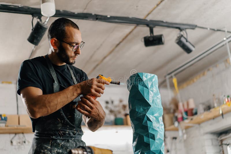 Artisan Sculptor Artist Mixes Using a Gas Burner for Burning Paint and